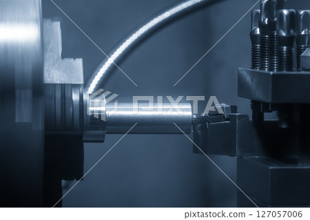 Closeup scene the lathe machine rough cut the metal parts in the light blue scene. Closeup scene the lathe machine rough cut the metal parts in the light blue scene. 127057006