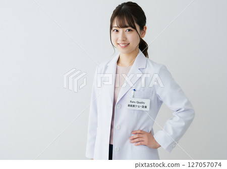 Portrait of a young female researcher wearing a white coat 127057074