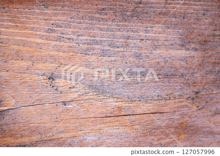 Old painted wood with crumbling paint. 127057996