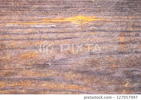 Old painted wood with crumbling paint. 127057997