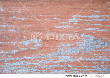 Old painted wood with crumbling paint. 127057998