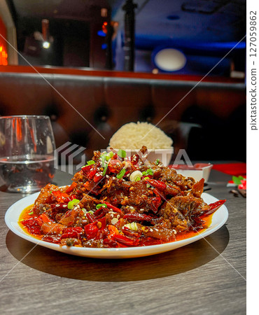 Spicy stir-fried pork with chili and sweet and sour sauce 127059862