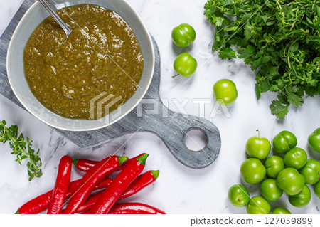 Tkemali sauce, made from green cherry plum, with ingredients on the table, top view, Georgian cuisine, no people, Tkemali sauce, made from green cherry plum, with ingredients on the table, top view, Georgian cuisine, no people, 127059899