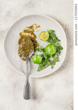 a spoon with tkemali sauce, on a plate, with cherry plum and mint, top view, no people, a spoon with tkemali sauce, on a plate, with cherry plum and mint, top view, no people, 127059902