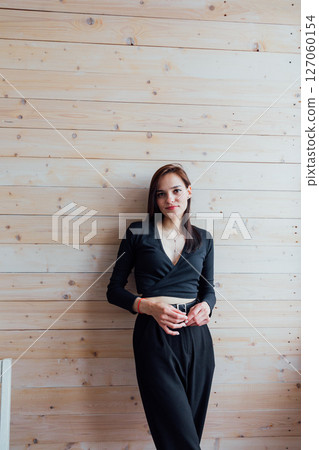 Portrait of a beautiful young brunette girl in black clothes Portrait of a beautiful young brunette girl in black clothes 127060154
