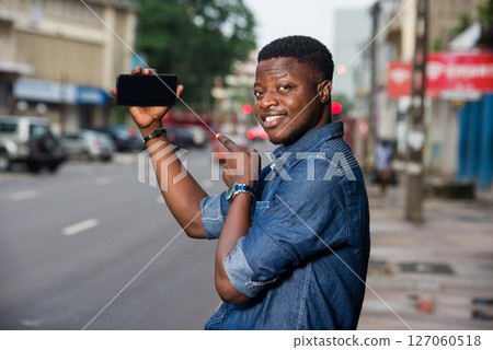 young smiling man presenting the new product showing the hand 127060518