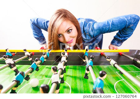 woman playing table football game 127060764