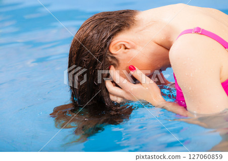 Woman having fun in swimming pool Woman having fun in swimming pool 127060859