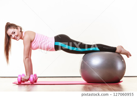 Fit girl exercising. 127060955