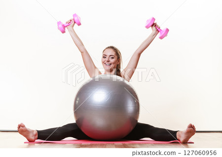 Cheerful brunette exercising. 127060956