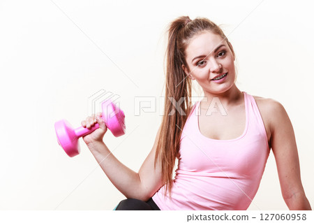 Sporty girl lifting weights. Sporty girl lifting weights. 127060958
