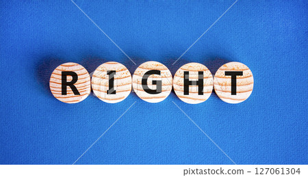Right symbol. Concept word Right on beautiful wooden circles. Beautiful blue table blue background. Business lifestyle right concept. Copy space. Right symbol. Concept word Right on beautiful wooden circles. Beautiful blue table blue background. Business lifestyle right concept. Copy space. 127061304