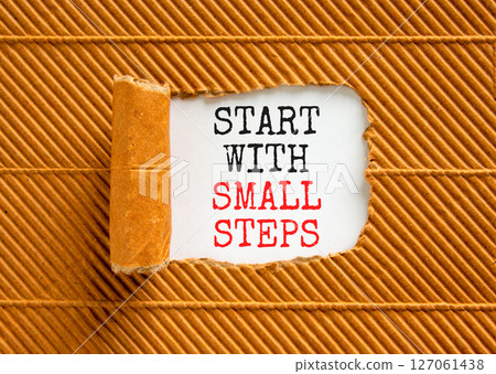 Start with small steps symbol. Concept words phrase Start with small steps on beautiful white paper. Beautiful brown paper background. Business Start with small steps concept. Copy space. Start with small steps symbol. Concept words phrase Start with small steps on beautiful white paper. Beautiful brown paper background. Business Start with small steps concept. Copy space. 127061438