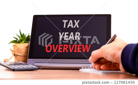 Tax year overview symbol. Concept words Tax year overview on beautiful black tablet. Beautiful white background. Businessman hand. Business tax year overview concept. Copy space. 127061450