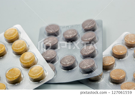 Colorful Pills in Blister Packs on White Background Colorful Pills in Blister Packs on White Background 127061559