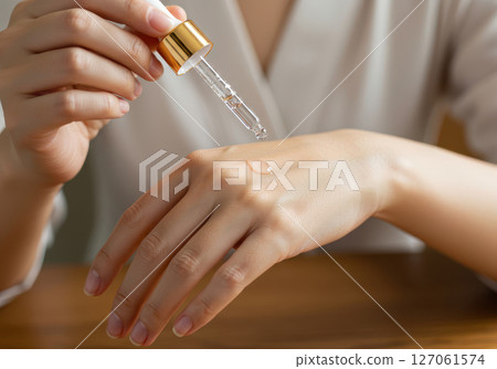 Close-up of hands applying moisturizing beauty oil (AI-generated image) Close-up of hands applying moisturizing beauty oil (AI-generated image) 127061574