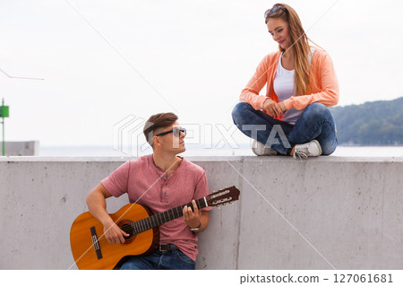 Cheerful couple spending time on coast. Cheerful couple spending time on coast. 127061681