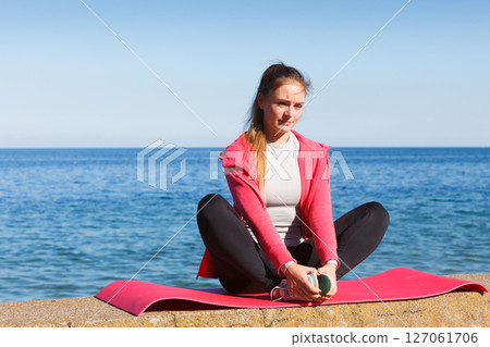Woman resting relaxing after doing sports outdoors Woman resting relaxing after doing sports outdoors 127061706