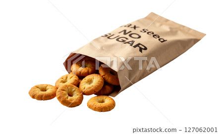 Kraft paper bag of flaxseed crackers is tilted, spilling some crackers onto a white background. The packaging emphasizes no sugar added and highlights its eco-style branding. 127062001