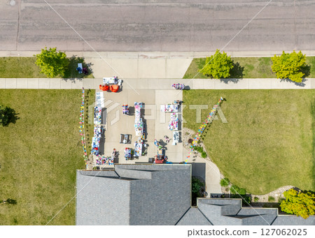 Aerial view above a garage yard sale in a residential area  127062025
