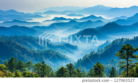 Misty Mountain Landscape with Layers of Blue Hues Misty Mountain Landscape with Layers of Blue Hues 127063527