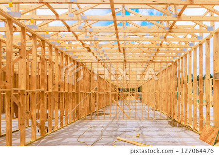Wooden framework being constructed for large building during construction works 127064476