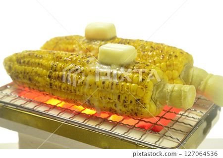 Cooking corn butter on a charcoal grill Cooking corn butter on a charcoal grill 127064536
