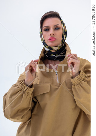 Portrait of young woman in scarf close-up on white background. Studio photography. Vertical photo. High quality photo Portrait of young woman in scarf close-up on white background. Studio photography. Vertical photo. High quality photo 127065916