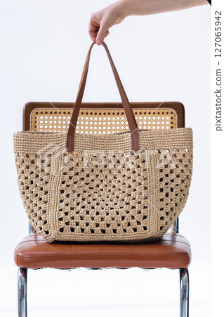 Female hand holding fashionable woven bag. Fashion and luxury accessories. Vertical photo. High quality photo Female hand holding fashionable woven bag. Fashion and luxury accessories. Vertical photo. High quality photo 127065942