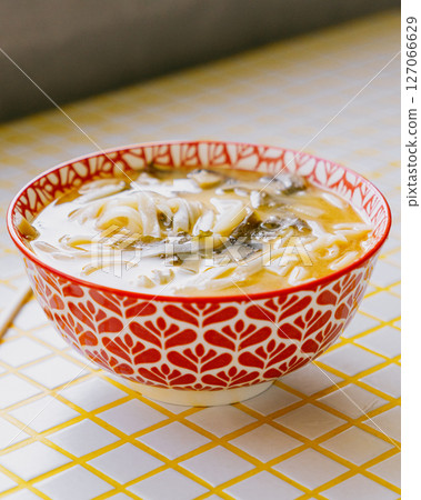plate of noodles and chopsticks. vegetable ramen in a bright blue plate. Asian dishes. 127066629