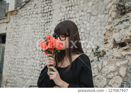 Young Woman Outdoor Smelling The Flowers She Received For Valentines Day Young Woman Outdoor Smelling The Flowers She Received For Valentines Day 127067407