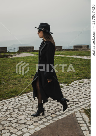 Woman Walking On The Stone Path Inside The Square  127067426