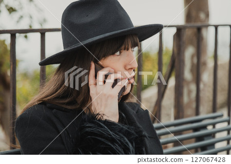 Elegant Dressed Woman On The Town Bench Having A Fun Call Close Up 127067428