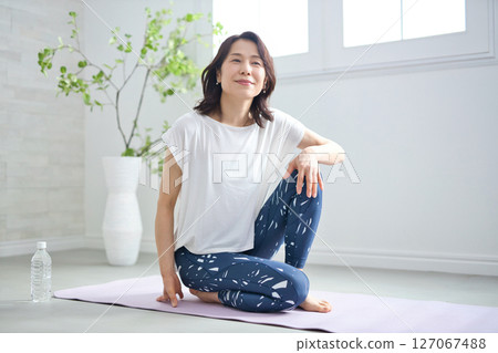 一位 50 多歲的女性穿著瑜伽服做瑜伽 一位 50 多歲的女性穿著瑜伽服做瑜伽 127067488