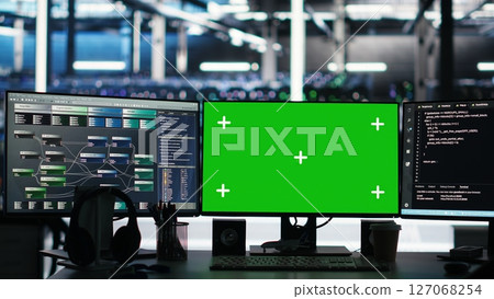 Mockup computers in data center facility manage supercomputers hardware energy consumption through node tree software. Green screen PCs automate server farm processes using visual programming tool 127068254