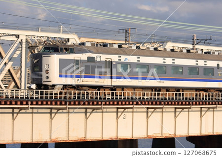 JR West 583 series express Kitaguni train crossing the Yodo River in the morning sun, photographed on August 26, 2010 JR West 583 series express Kitaguni train crossing the Yodo River in the morning sun, photographed on August 26, 2010 127068675