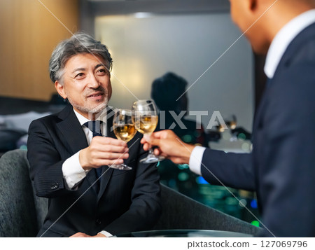 Multinational business people toasting with the city night view in the background 127069796
