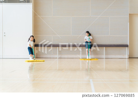 Girl cleaning the gym 127069885