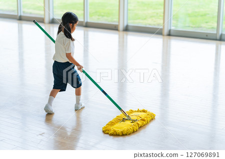 A girl mopping the gym 127069891