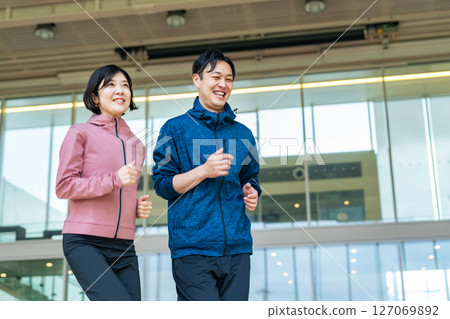 Middle-aged couple running indoors 127069892