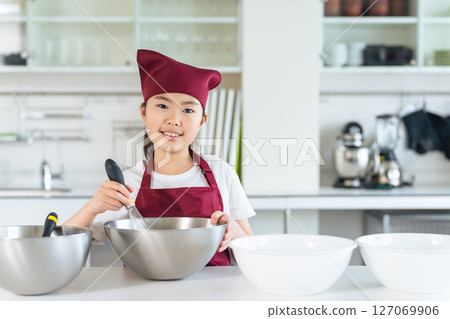 Girl cooking in the kitchen 127069906