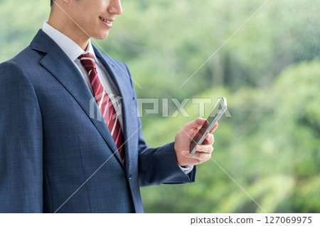 Businessmen (parts) who operate smartphones 127069975