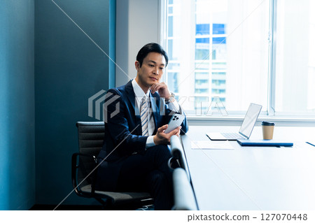 A businessman who uses a personal computer at the office 127070448