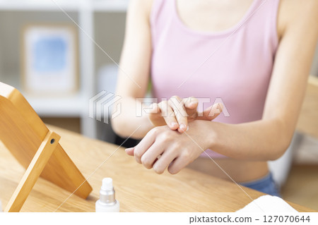 Beauty image: A woman's hand holding cosmetics 127070644