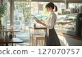 A woman working in a cafe 127070757