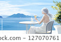 Gray-haired woman drinking wine on a terrace 127070761