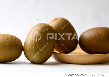 Fresh kiwi fruit with wooden plate on white background, Healthy fruit 127071829