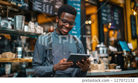 young entrepreneur using tablet in vibrant cafe, engaged in financial services 127072132