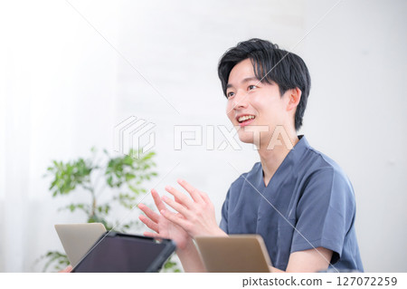 A man in casual clothes having a meeting, proposal, or business negotiation in an office A man in casual clothes having a meeting, proposal, or business negotiation in an office 127072259