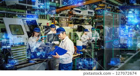 Group of workers operating machines in factory with digital technology concept Group of workers operating machines in factory with digital technology concept 127072674